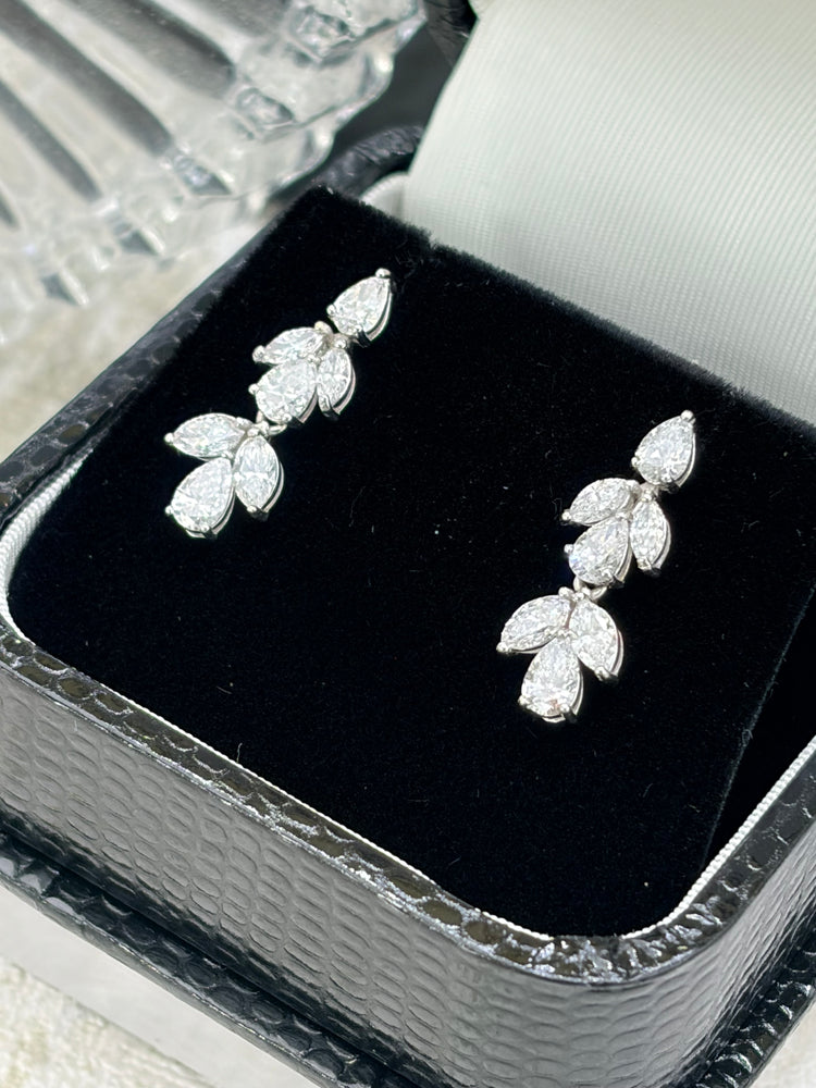 Marquise and pear cut diamond drop earrings on black velvet
